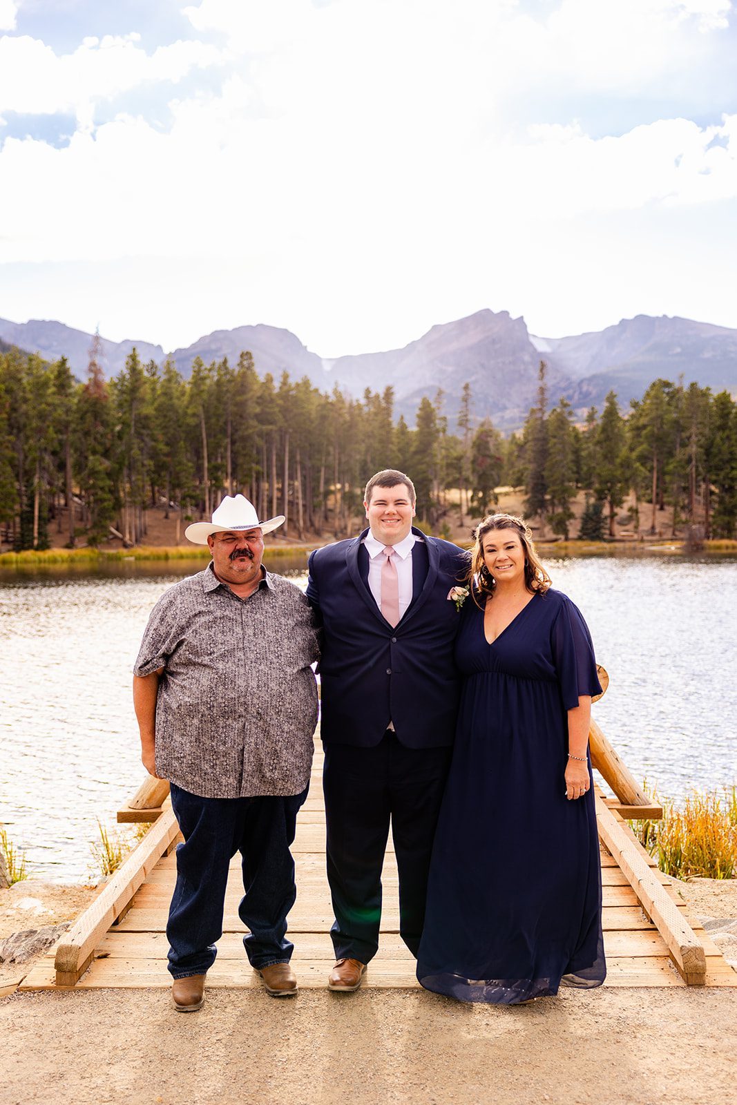 Groom with hie parents after Fall elopement ceremony at Sprague Lake
