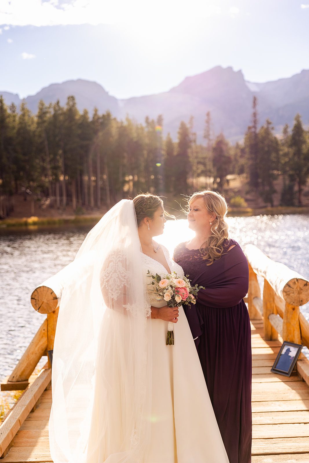 bride with her mother pose together  after Fall elopement at Sprague Lake. 