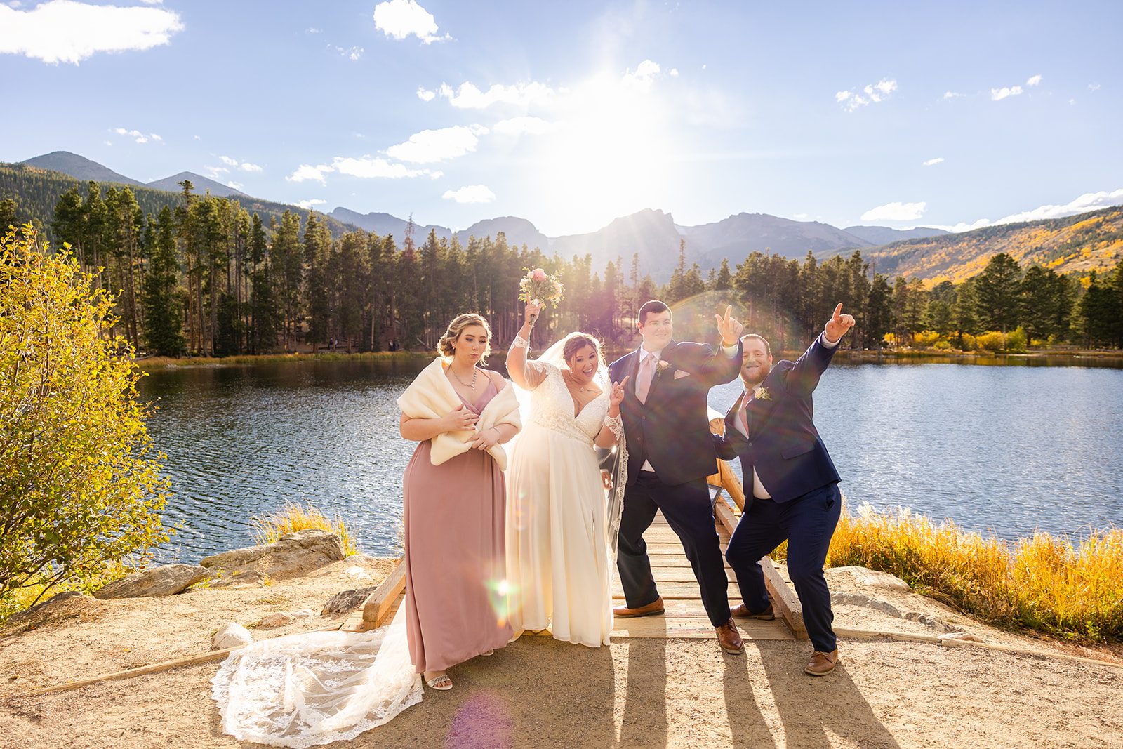 Bride and groom pose with bridal party after Fall elopement at Sprague Lake
