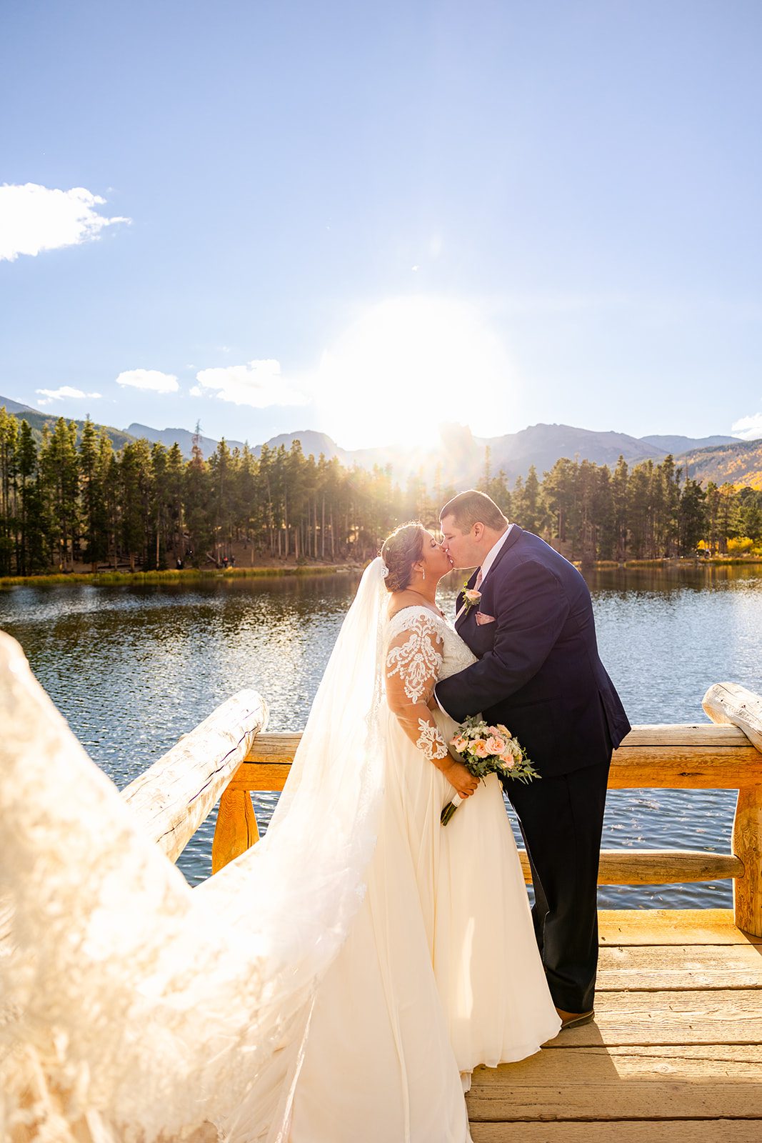 Bride and groom kissing after their intimate elopement at Sprague Lake. 