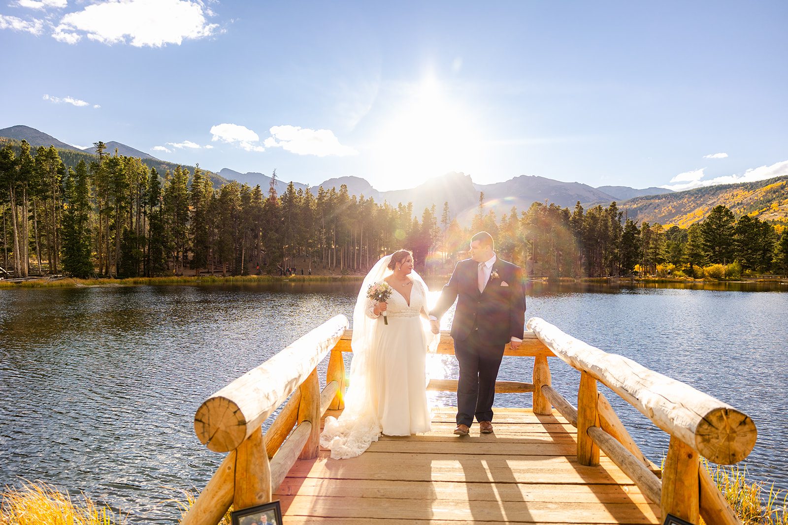 Sunset photo of bride and groom at at Sprague Lake after their fall elopement ceremony. 