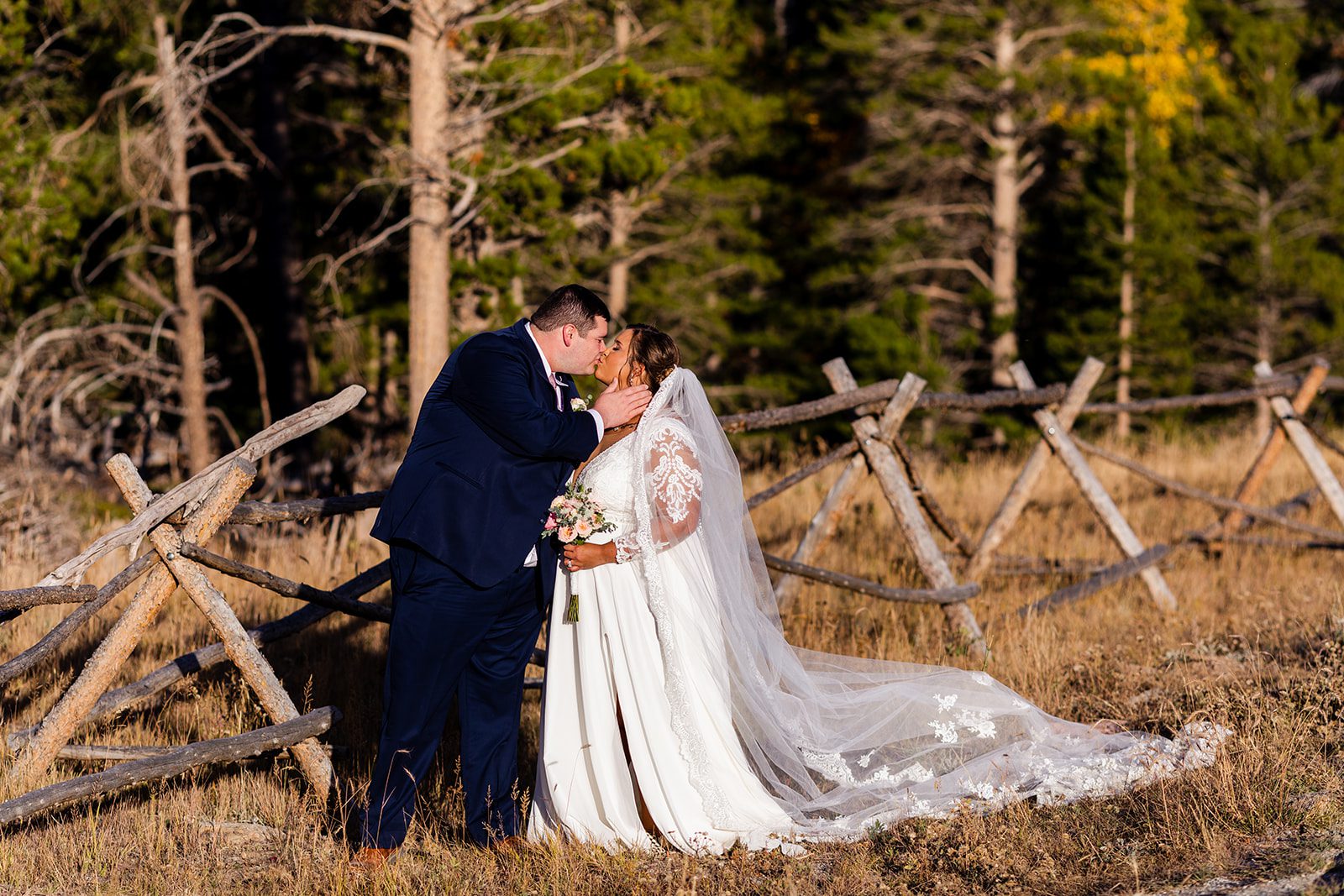 bride and groom kissing after their Fall elopement at Sprague Lake. 