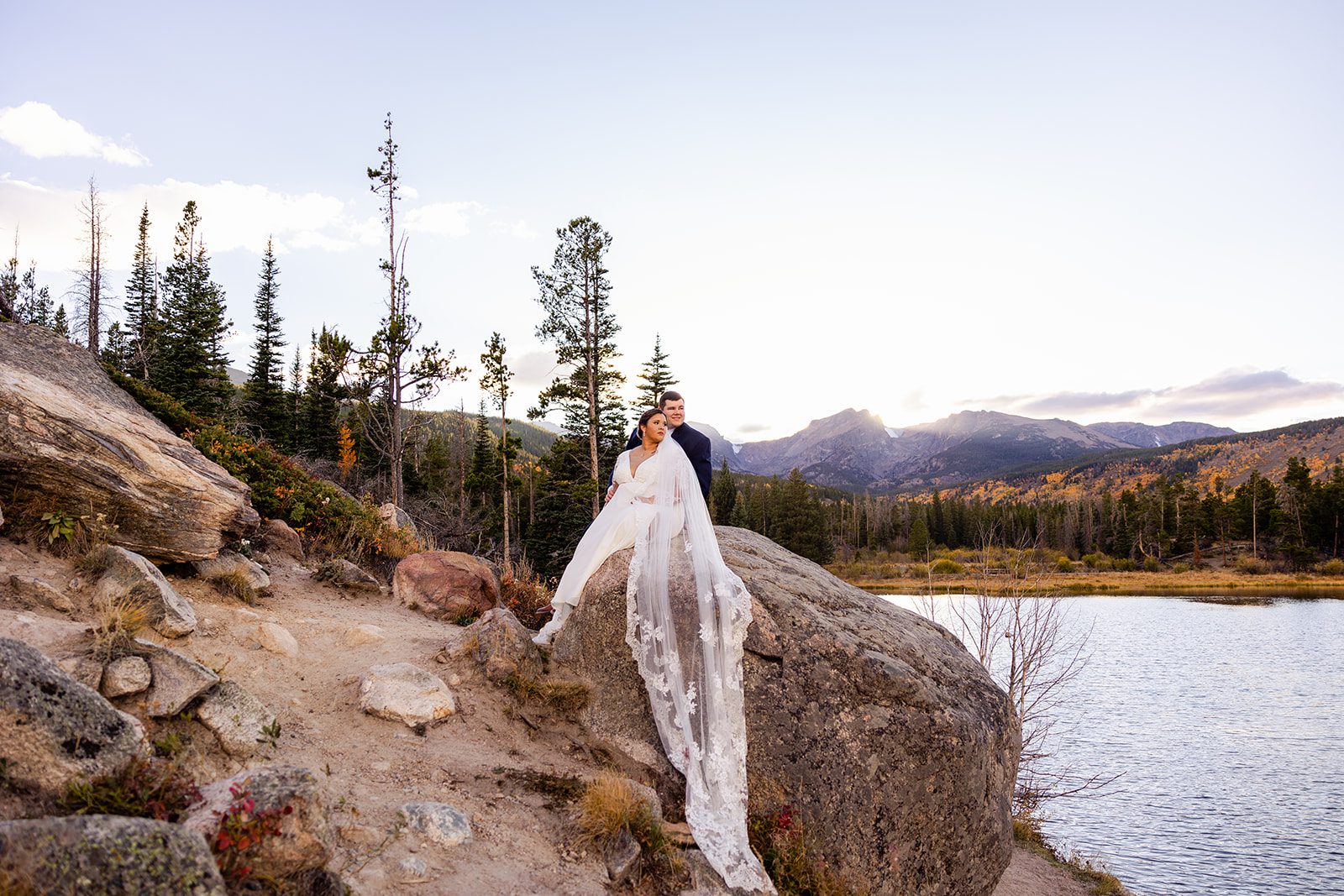 bride and groom looking over Sprague Lake after their Fall elopement. 