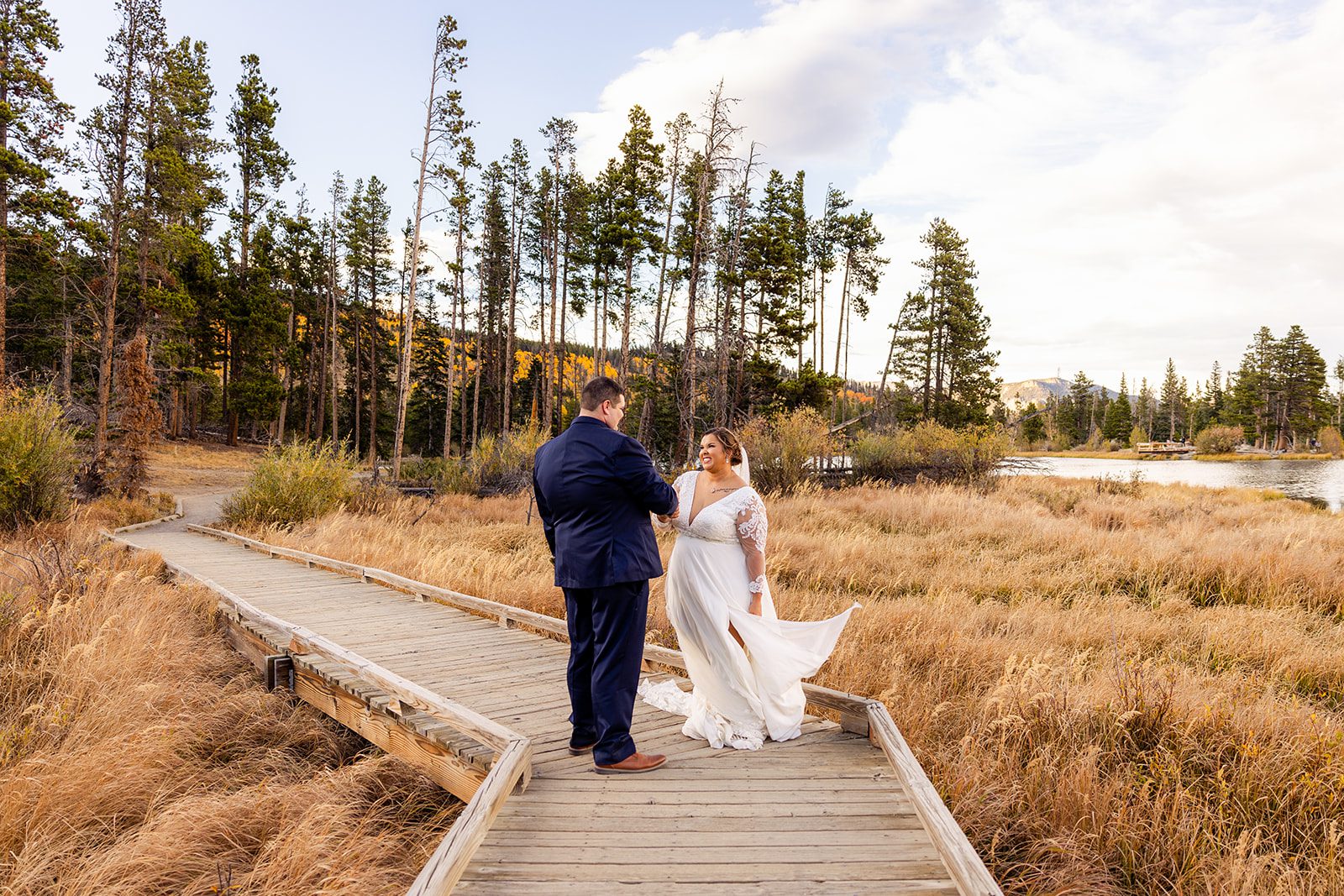 bride and groom during fall, at sprague lake in rocky mountain national park 